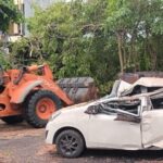 Doc. Proses evakuasi mobil yang ringsek akibat tertimpa pohon besar di Jalan Raya Kuta, Bali. Alat berat digunakan untuk membersihkan puing-puing pohon agar lalu lintas kembali normal. Warga sekitar turut menyaksikan jalannya evakuasi. (Bali, 22/3/2025 – Foto Dokumentasi: Umbu Arfin).